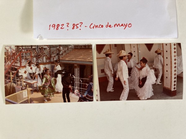 Two photos on a table of people in traditional Mexican dress with a note that says 1982? 1985? Cinco de Mayo