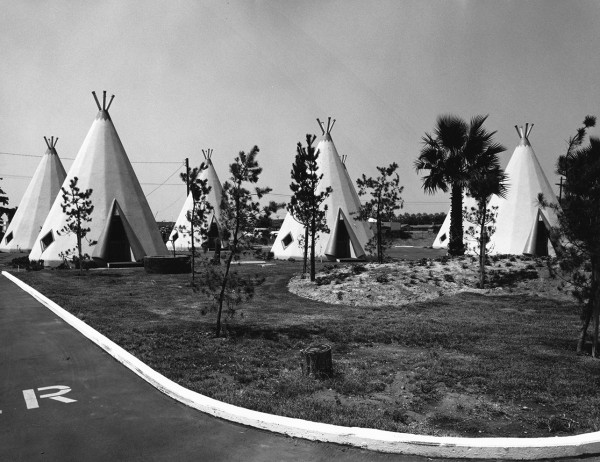 a black and white photo of a bunch of concrete buildings that are shaped like tipis.