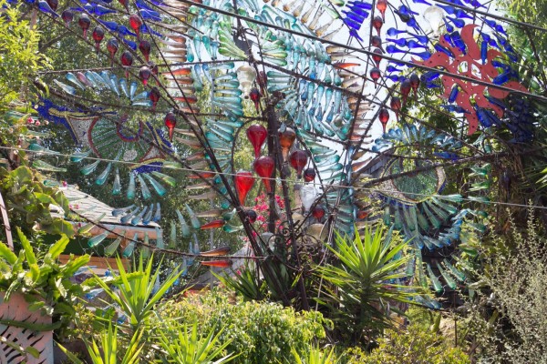 Phantasma Gloria in Los Angeles, California featuring colored bottles on rebar with greenery surrounding.