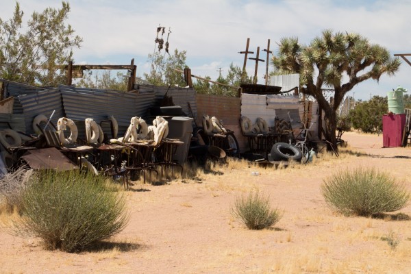 An installation of corrugated metal, tires, and other found objects.